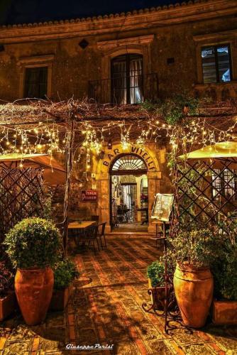 a courtyard with lights and potted plants in a building at Savoca Loft S. Antonio in Savoca 