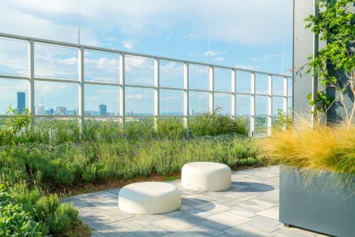 two white stools sitting on top of a building at Vienna Residence, Marina Tower - Danube in Vienna