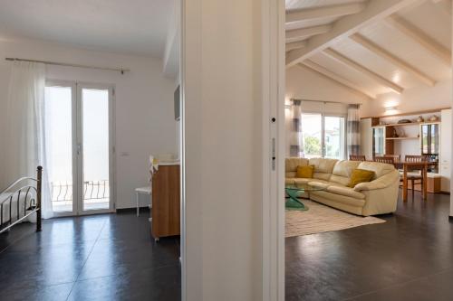 a living room with a couch and a table at Sa Omu Bianca in Tortolì
