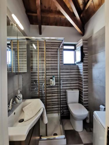 a bathroom with a sink and a toilet and a tub at LaZaRTe in Mytilene