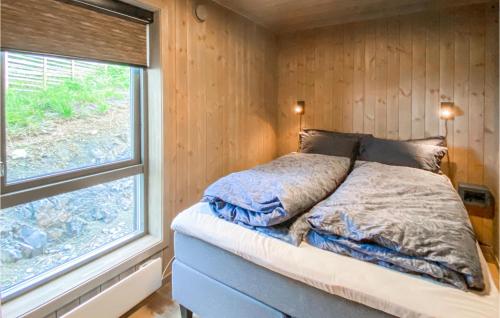 a bed in a small room with a window at Amazing Home In Aurdal With Wifi And 4 Bedrooms in Aurdal