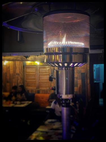 a large lamp in a room with a table at La Casa Blu in Antananarivo