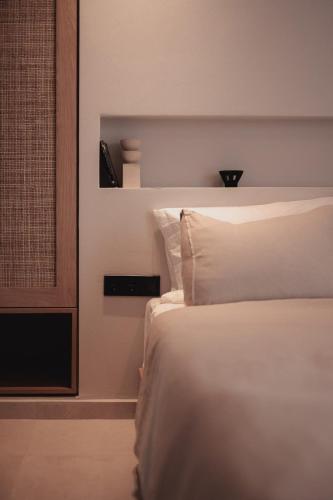 a bedroom with a white bed and a window at Om Living Afitos in Afitos