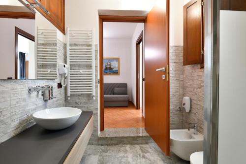 a bathroom with a sink and a tub and a toilet at Sa Omu Bianca in Tortolì