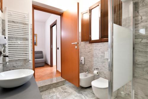 a bathroom with a toilet and a sink at Sa Omu Bianca in Tortolì