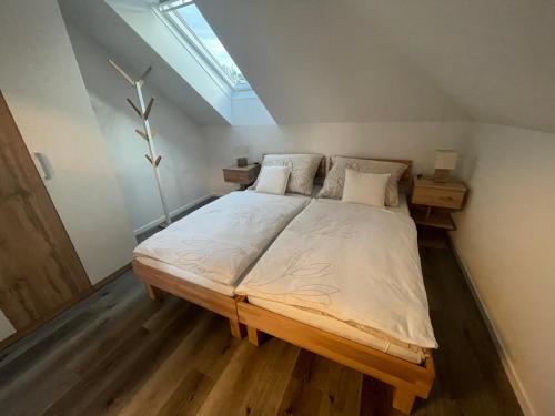 a bedroom with a large bed with a skylight at Sorinas Home - Comfortable Apartment near Graz - Free Parking in Wagersbach