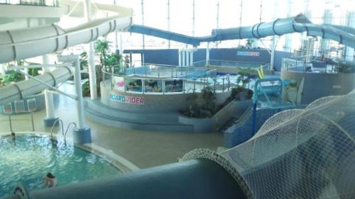 a water slide in a water park with a pool at Knocking on Gower's Door, Swansea in Swansea