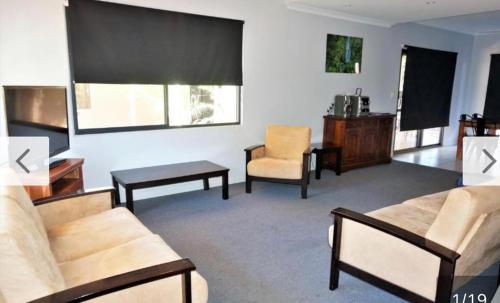 a living room with a couch and a chair at The Ningaloo breeze villa 4 in Exmouth