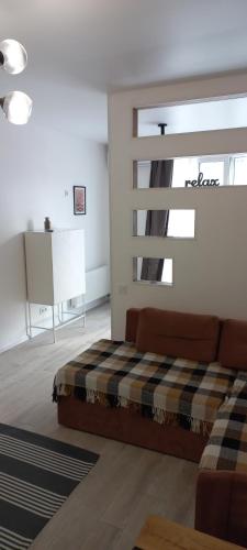 a living room with a couch and a window at Sweet Home in Kyiv