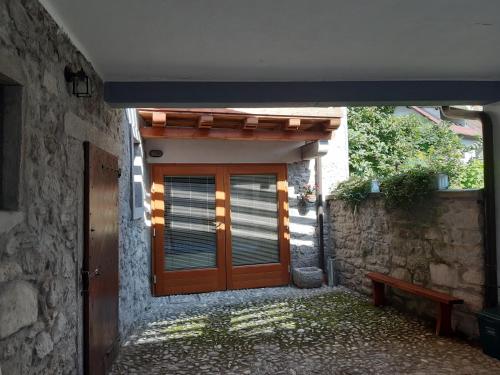 a door of a house with a bench in front of it at Mountain Lodge in Raveo
