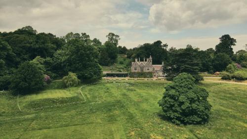 an aerial view of a large house in a field at Wildhive Callow Hall in Ashbourne