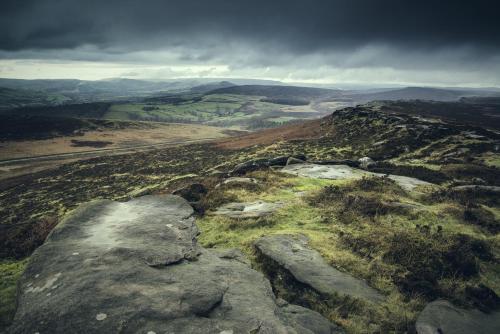 a rock on top of a mountain with a view at Wildhive Callow Hall in Ashbourne