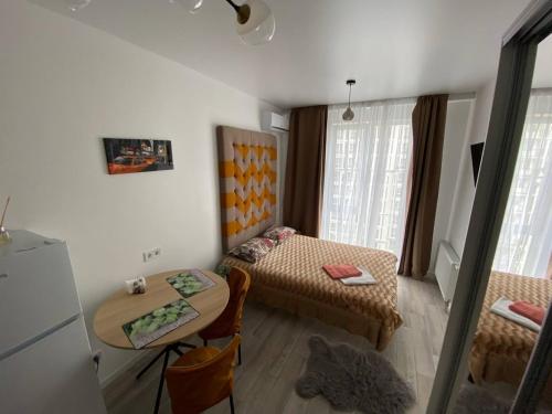 a small room with two beds and a table at Sweet Home in Kyiv