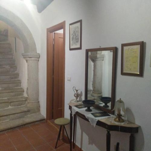 a room with a table and a mirror and stairs at VILLA GIANNINA (Loft) in Teggiano