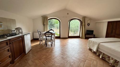 a bedroom with a bed and a table and chairs at Il Borgo Di San Michele in Papigno
