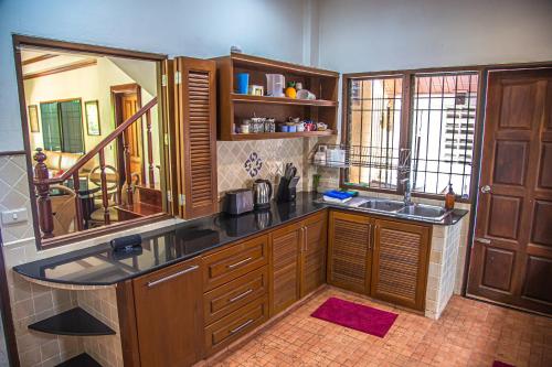 a kitchen with a sink and a mirror at Kata Pool Villa ​No.7 in Kata Beach