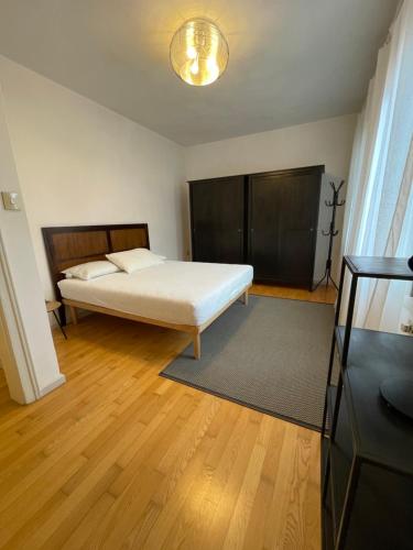 a bedroom with a white bed and a wooden floor at Ca' Liberty in Venice-Lido