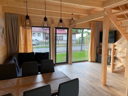 a large living room with a table and chairs at Ośrodek Wypoczynkowy Złote Piaski in Jarosławiec