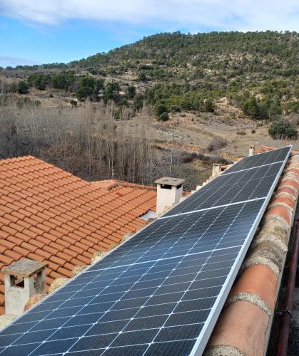 a group of solar panels on the roof of a house at Ciudad Encantada Tio Daniel in Valdecabras