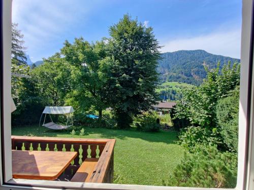 a view from a window of a yard with a picnic table at AppartChalet LA RONDULA - 100m from Seceda in Ortisei