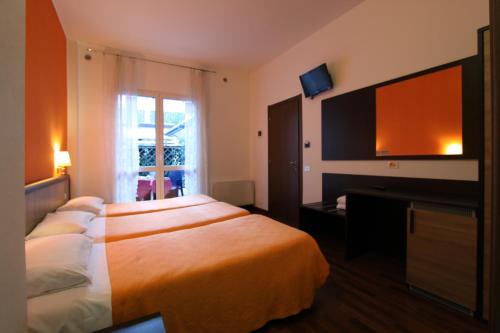 Una cama o camas en una habitación de Lux Hotel Durante