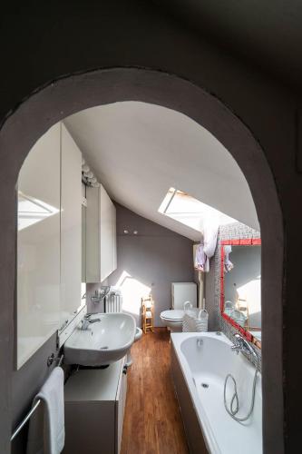 a bathroom with two sinks and a bath tub at Hbhall Residenze Darsena in Milan