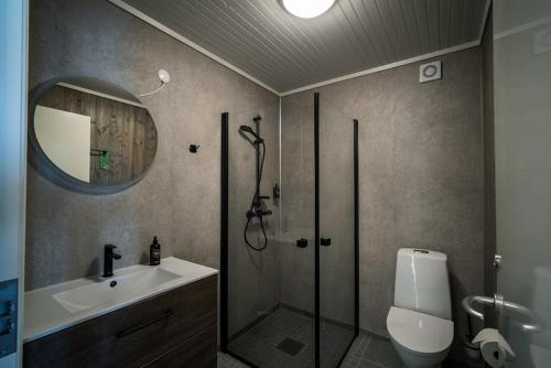 a bathroom with a shower and a toilet and a sink at Ona Havstuer - by Classic Norway Hotels in Ona