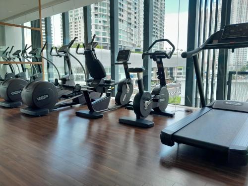 a gym with a row of cardio bikes and treadms at The Landmark Comfort Relax Spacious Sea View By IZ in Tanjong Tokong