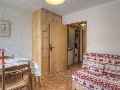 - un salon avec un canapé et une armoire en bois dans l'établissement Studio cosy pour 2, Serre-Chevalier Chantemerle - Proche pistes, parking, casier à ski, animaux acceptés - FR-1-330E-62, à Saint-Chaffrey