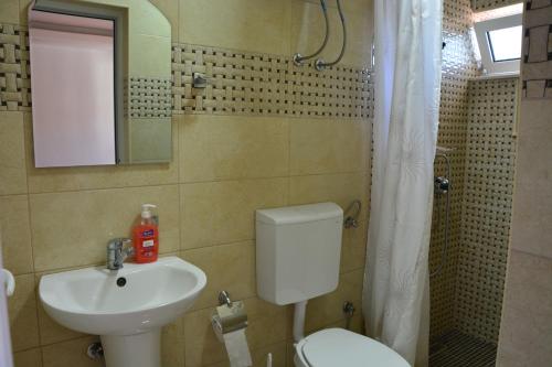 a bathroom with a toilet and a sink at Guest House Vera in Ulcinj
