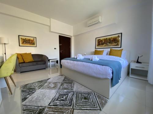 a bedroom with a king sized bed and a couch at Lemon Tree Residence in Amman