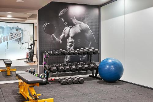 a gym with a picture of a man holding a mirror at Casa di Fiore SPA and Medical Hotel, Mineral Pools & Private Beach in Kranevo