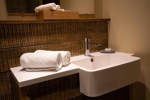 a bathroom with a sink with towels on it at The Inn South Stainley in Harrogate