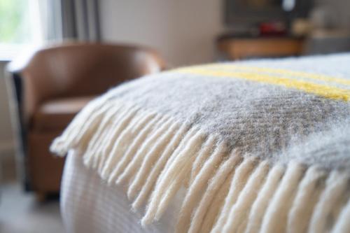 a close up of a white blanket on a bed at The Inn South Stainley in Harrogate