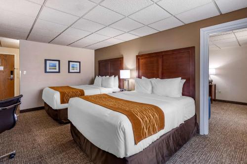 a hotel room with two beds and a television at Comfort Inn Butte City Center I-15 - I-90 in Butte