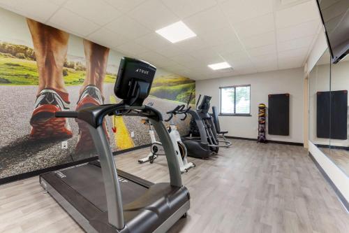 a gym with several treadmills and cardio machines at Clarion Pointe Tomah in Tomah