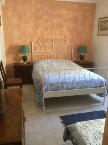 a bedroom with a white bed and two lamps at Vintage apartment Milfontes in Vila Nova de Milfontes