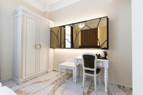 a bedroom with a desk with a chair and a mirror at Modern Revival Luxury Hotel in Thessaloniki