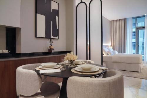 a living room with a table and two chairs at Lusso Hometels J One Business Bay in Dubai