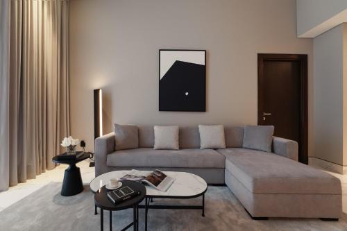 a living room with a couch and a table at Lusso Hometels J One Business Bay in Dubai