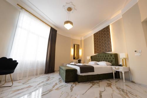 a hotel room with a bed and a large window at Modern Revival Luxury Hotel in Thessaloniki