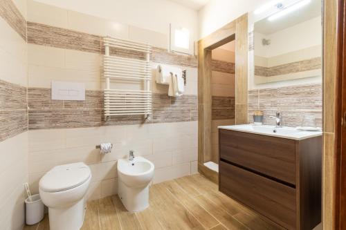 a bathroom with a toilet and a sink at Masseria dei Monaci in Otranto