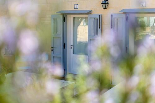 a front door of a house with purple doors at Masseria dei Monaci in Otranto