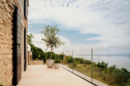 a balcony with a view of the water at FAVAI HILLS your secret hideaway in Brenzone sul Garda