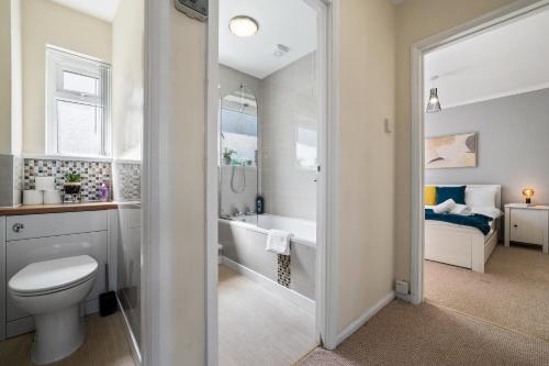 a bathroom with a toilet and a sink and a tub at Stay In Cardiff Cathay's Terrace Apartment in Cardiff