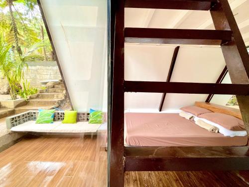 a bunk bed in a room with a window at A-frame Villa at Tierra Verde, “Little Baguio” Real, Quezon in Quelalag