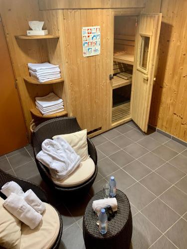 a room with two chairs and tables in a room at Hameau des Prodains - Résidence in Morzine