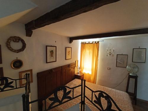 a bedroom with a bed and a window at Giglio Vallerano. Alloggio turistico in Vallerano