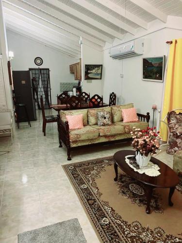 a living room with a couch and a table at L&V Paradise Vacation # 1 in Florence Hall