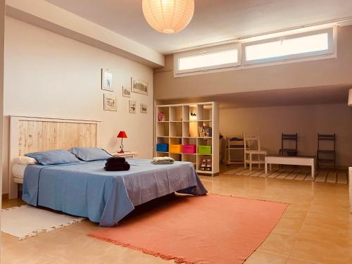 a bedroom with a bed with a blue comforter at Faro beach&pool in Cotillo